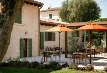 Area esterna con tavoli e ombrelloni arancioni al beach club Punta San Vigilio