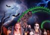 Persone in costume su montagne russe durante Halloween a Gardaland.