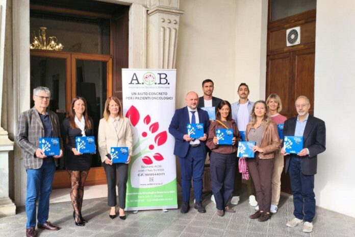 Un gruppo di persone tiene cioccolatini davanti al palazzo della Presidenza della Provincia di Brescia