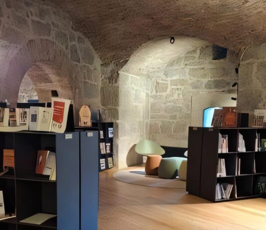 Ambiente interno con scaffali e sedie in una stanza sotterranea al Forte di Nago