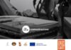 Manifesto di Consorzio Garda DOC mostra ufficio con computer e simboli istituzionali